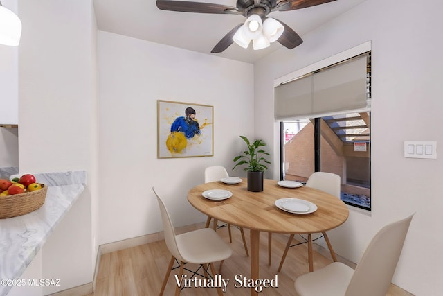 dining room with ceiling fan and light wood-type flooring