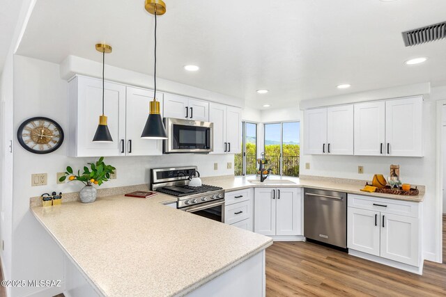 4725 N Placita De Concha, Tucson, AZ 85745 - kitchen featuring stainless steel appliances, a peninsula, white cabinets, light countertops, and recessed lighting