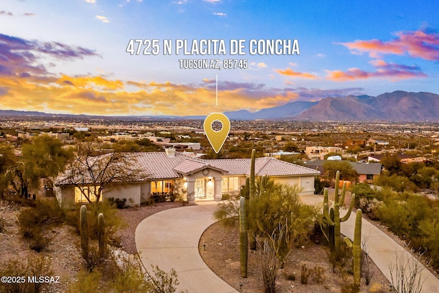 4725 N Placita De Concha, Tucson, AZ 85745 - mediterranean / spanish house with a tile roof, a mountain view, stucco siding, and curved driveway