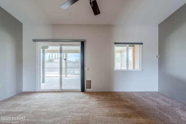 carpeted spare room with ceiling fan