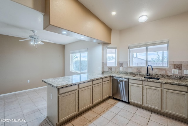 kitchen with sink, dishwasher, light brown cabinetry, decorative backsplash, and kitchen peninsula