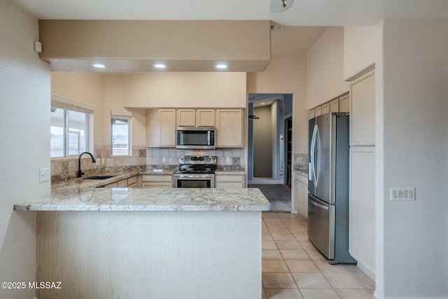 kitchen with sink, decorative backsplash, stainless steel appliances, and kitchen peninsula