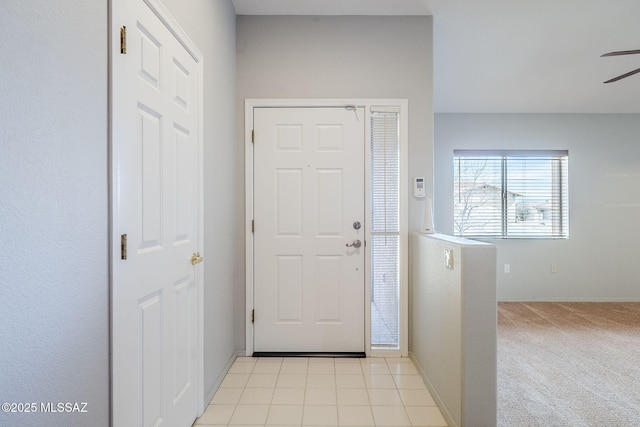 entryway featuring ceiling fan and light colored carpet