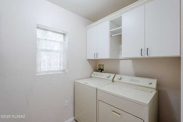 washroom with cabinets and washing machine and clothes dryer