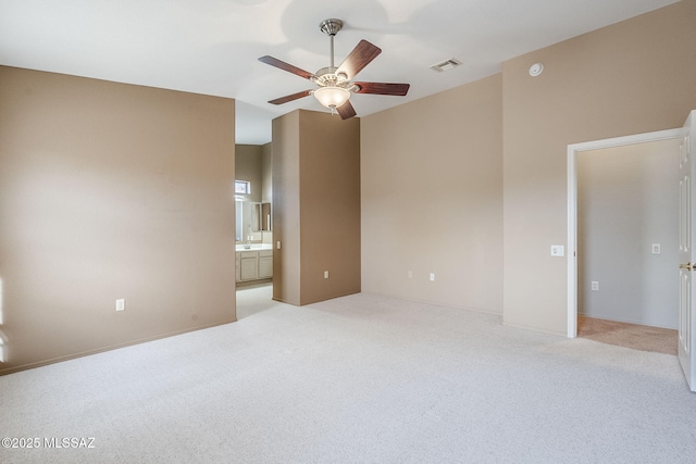 empty room featuring light colored carpet and ceiling fan