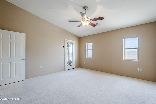 spare room with ceiling fan, light colored carpet, and lofted ceiling