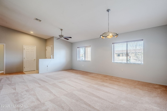 carpeted spare room with lofted ceiling and ceiling fan