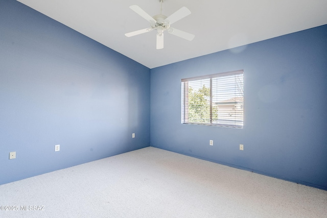 carpeted empty room featuring ceiling fan and lofted ceiling