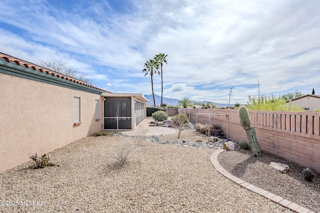 view of yard with a sunroom and a patio