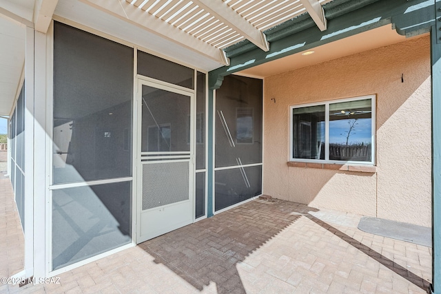 doorway to property with a pergola and a patio area