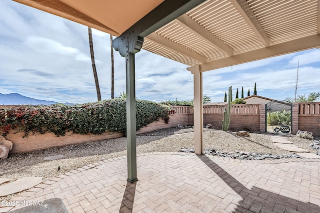 view of patio / terrace with a pergola and a mountain view