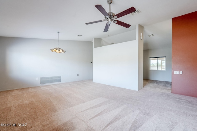 empty room with ceiling fan, lofted ceiling, and light carpet