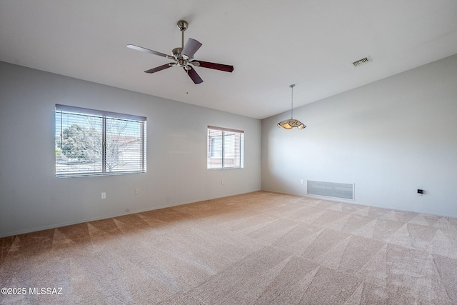 unfurnished room featuring vaulted ceiling, light colored carpet, and ceiling fan