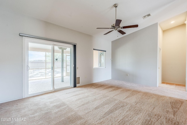 unfurnished room with ceiling fan, vaulted ceiling, and light carpet