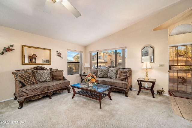 living room featuring ceiling fan, vaulted ceiling, and light carpet