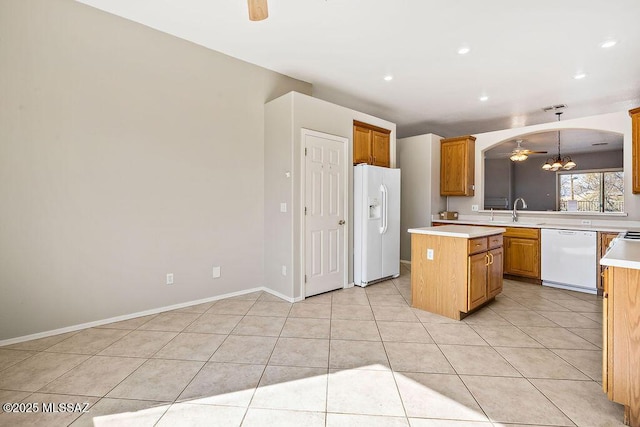 kitchen with ceiling fan with notable chandelier, a center island, pendant lighting, and white appliances