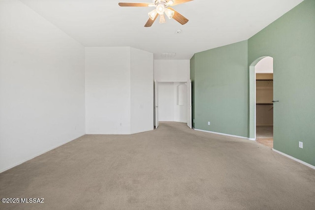 carpeted spare room featuring ceiling fan