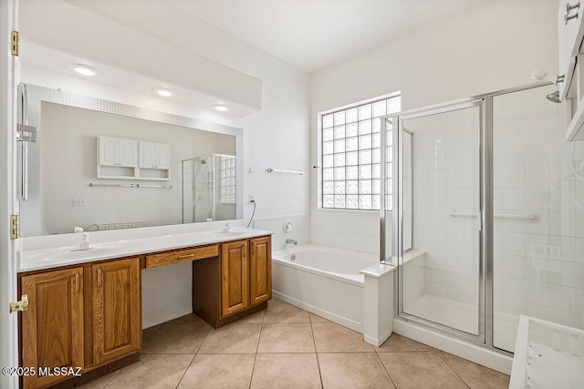 bathroom featuring tile patterned flooring, vanity, and shower with separate bathtub