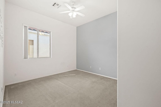 carpeted empty room featuring ceiling fan