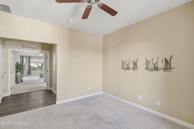 unfurnished room with ceiling fan and carpet