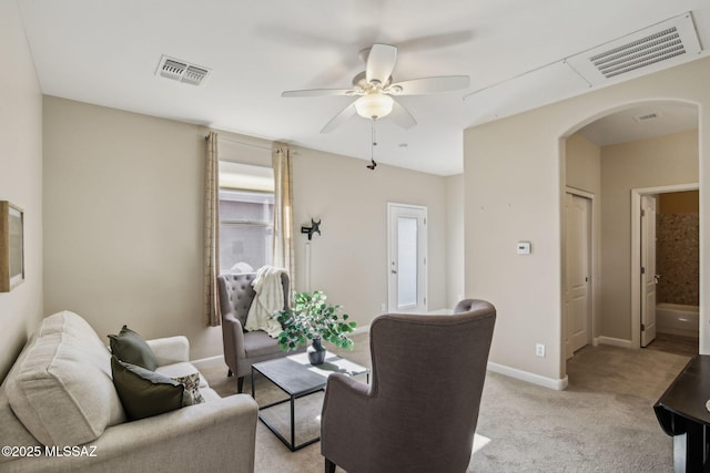 carpeted living room with ceiling fan