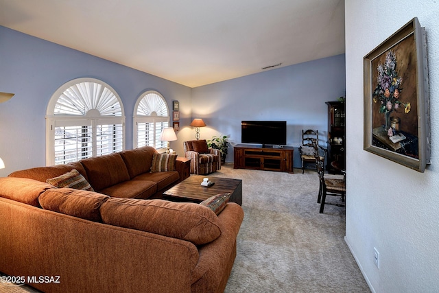 living room featuring lofted ceiling and carpet floors