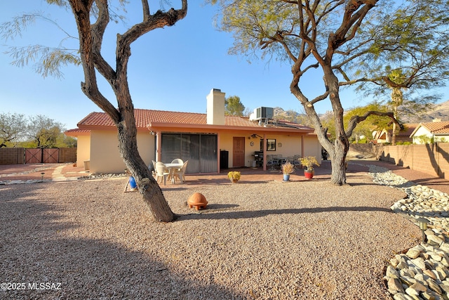 back of house featuring cooling unit and a patio area