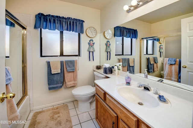 full bathroom featuring bath / shower combo with glass door, tile patterned floors, toilet, and vanity