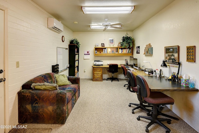 carpeted office with ceiling fan, brick wall, built in desk, and a wall unit AC