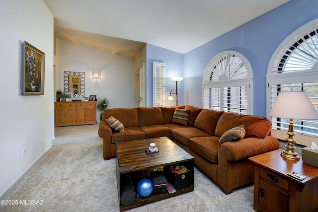 living room featuring light carpet and vaulted ceiling