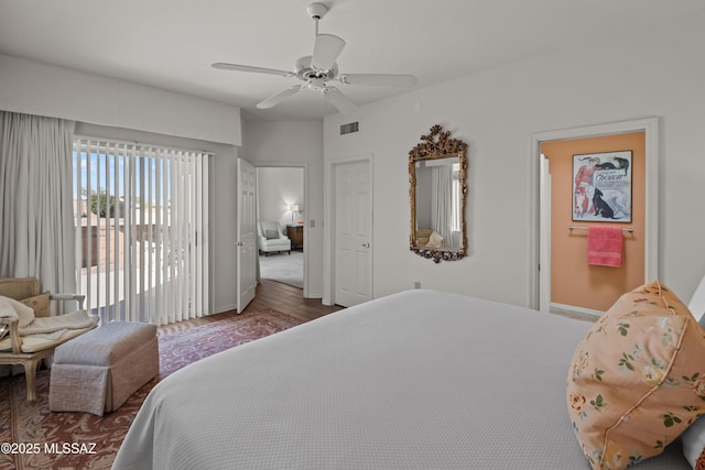 bedroom with ceiling fan, dark hardwood / wood-style flooring, and access to outside