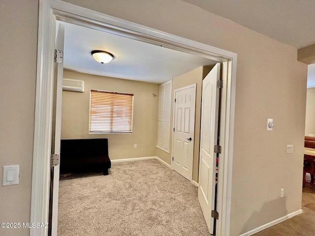 hallway with light carpet and a wall unit AC