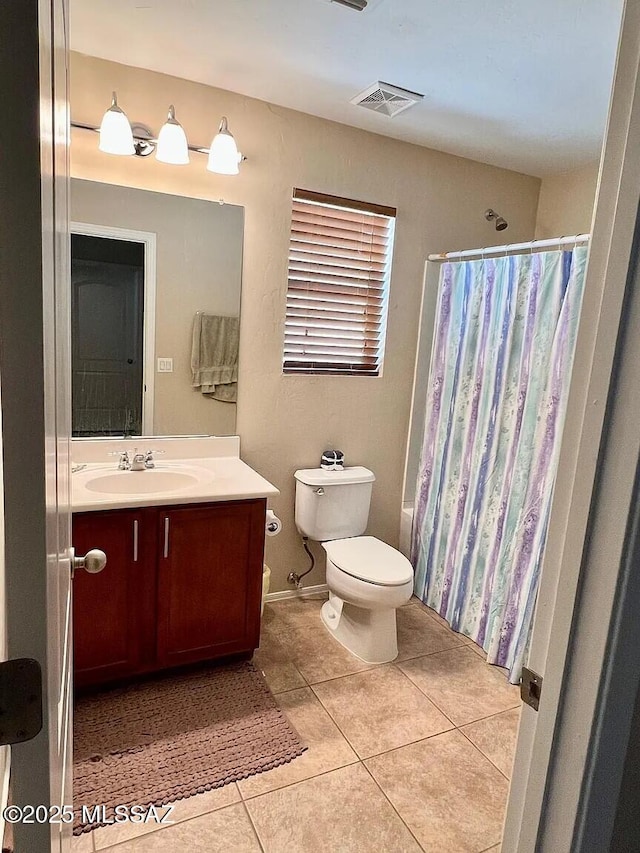 bathroom with vanity, tile patterned floors, and toilet