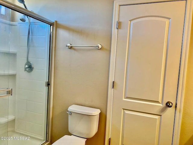 bathroom featuring toilet and walk in shower