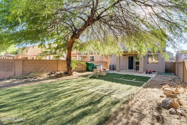 view of yard with central AC and a patio area