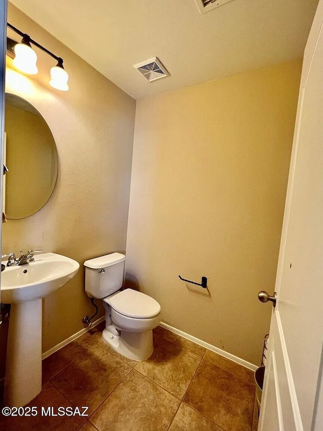 bathroom with tile patterned floors, toilet, and sink