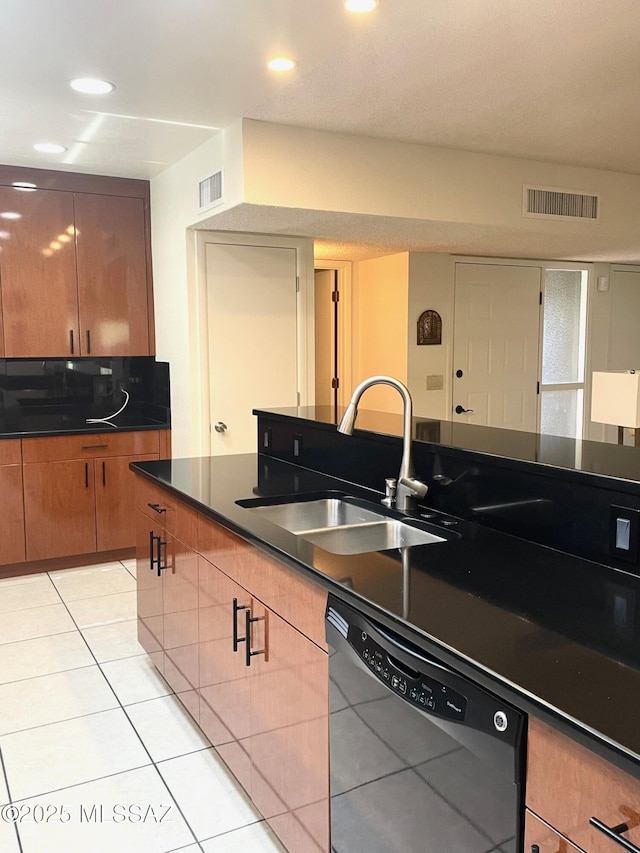 kitchen featuring light tile patterned flooring, dishwasher, and sink