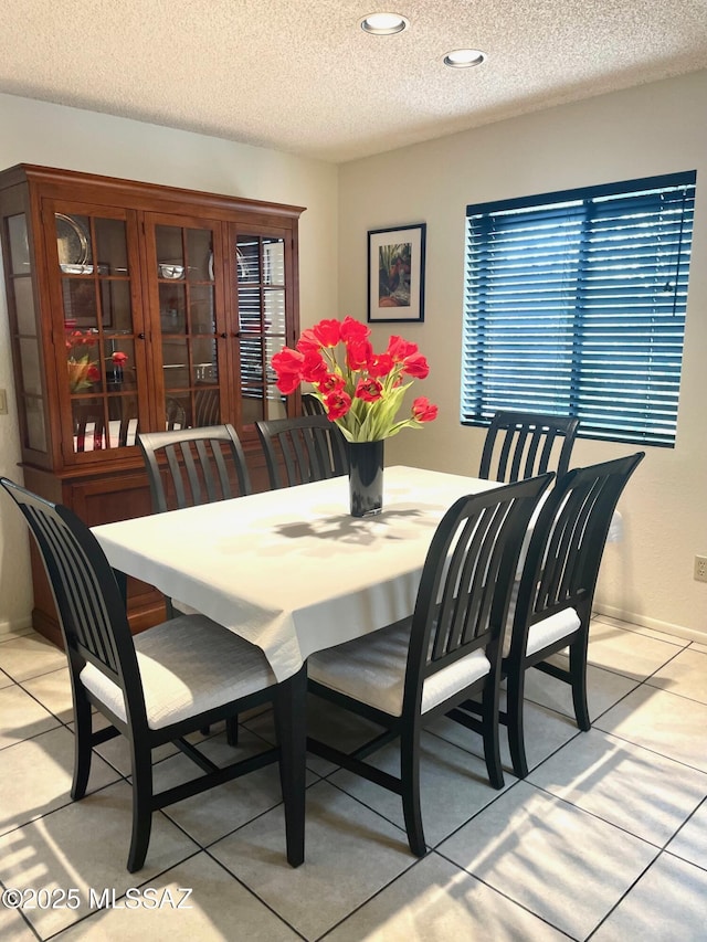 dining space with a textured ceiling