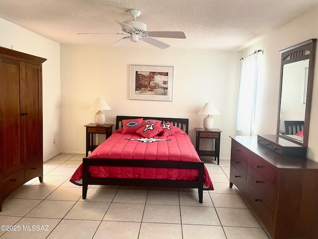 tiled bedroom featuring ceiling fan and a textured ceiling