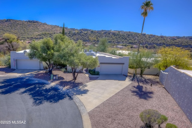 exterior space with a garage and a mountain view