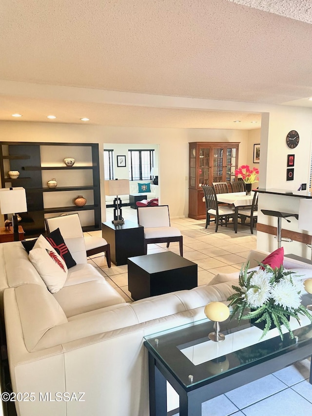 living room featuring light tile patterned floors and a textured ceiling