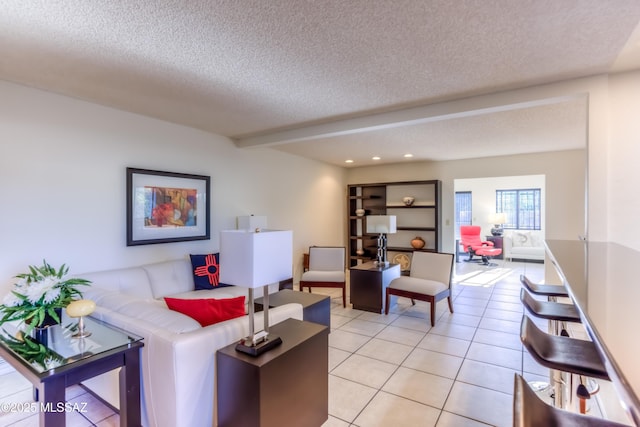 tiled living room featuring a textured ceiling