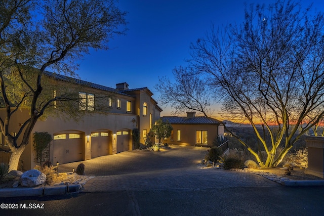 mediterranean / spanish-style home featuring a garage