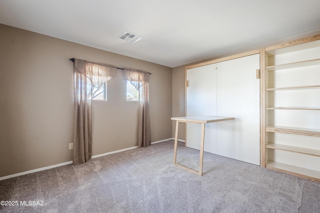 unfurnished bedroom featuring visible vents, carpet floors, and baseboards