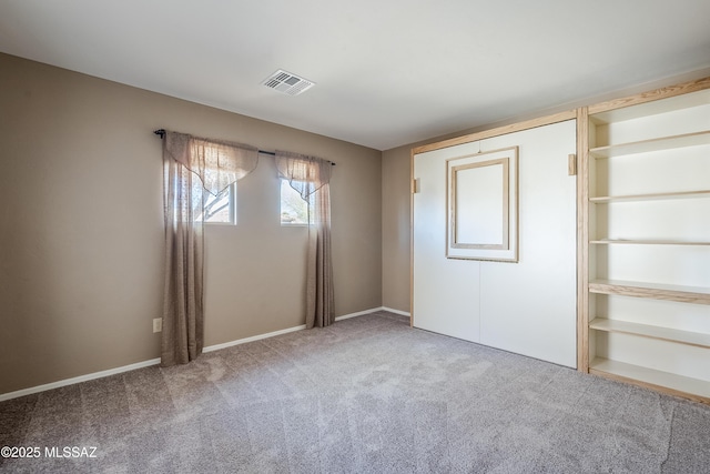 unfurnished bedroom featuring carpet flooring and visible vents