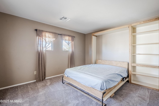 carpeted bedroom with visible vents and baseboards