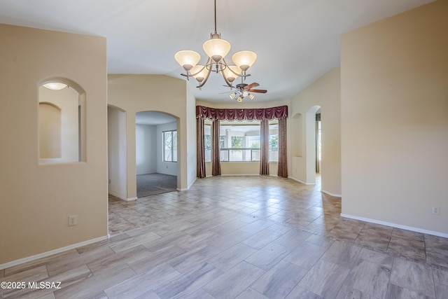 unfurnished room with ceiling fan with notable chandelier, vaulted ceiling, baseboards, and arched walkways