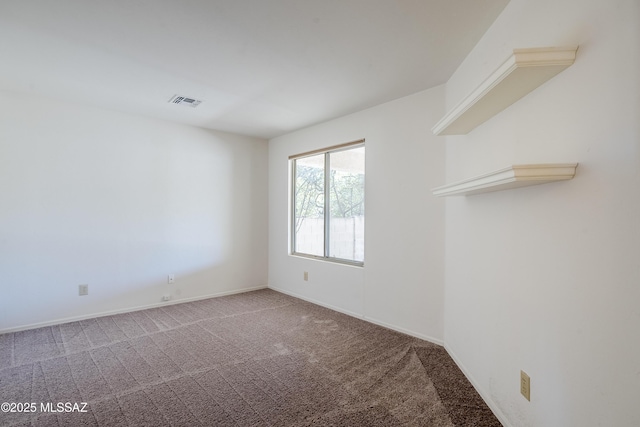 unfurnished room with visible vents, baseboards, and carpet floors