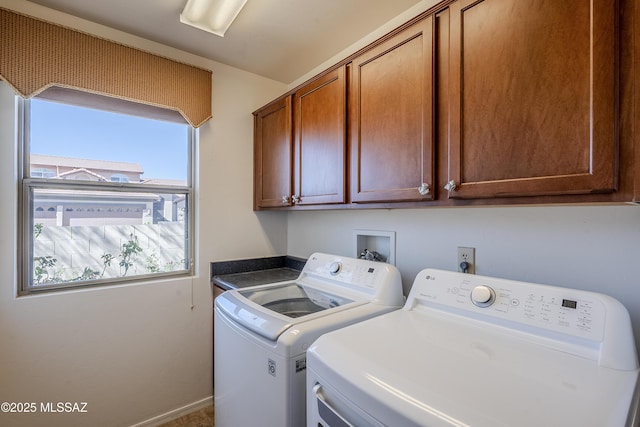 laundry room featuring baseboards, cabinet space, and independent washer and dryer