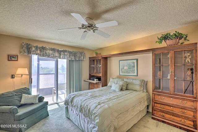 bedroom with access to exterior, a ceiling fan, a textured ceiling, and light colored carpet